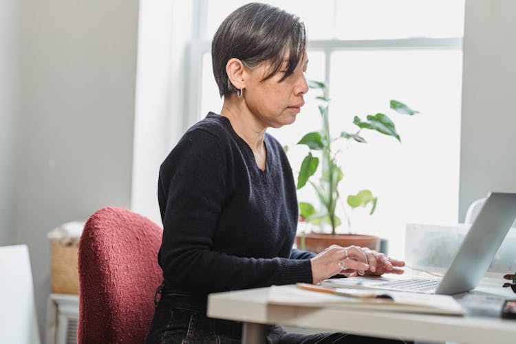 Woman Browsing The Internet By Using A Laptop