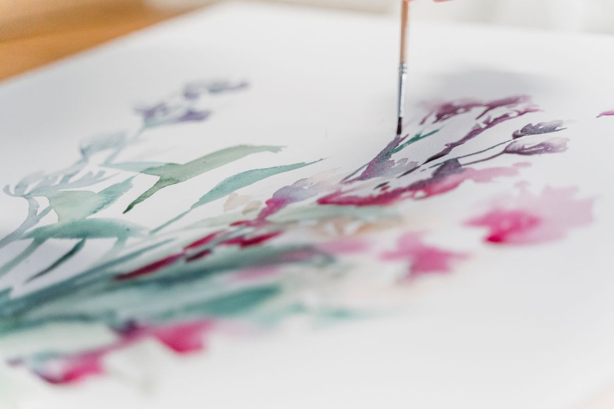 Loose watercolour flowers being painted on cold-press paper — photo by Greta Hoffman on Pexels