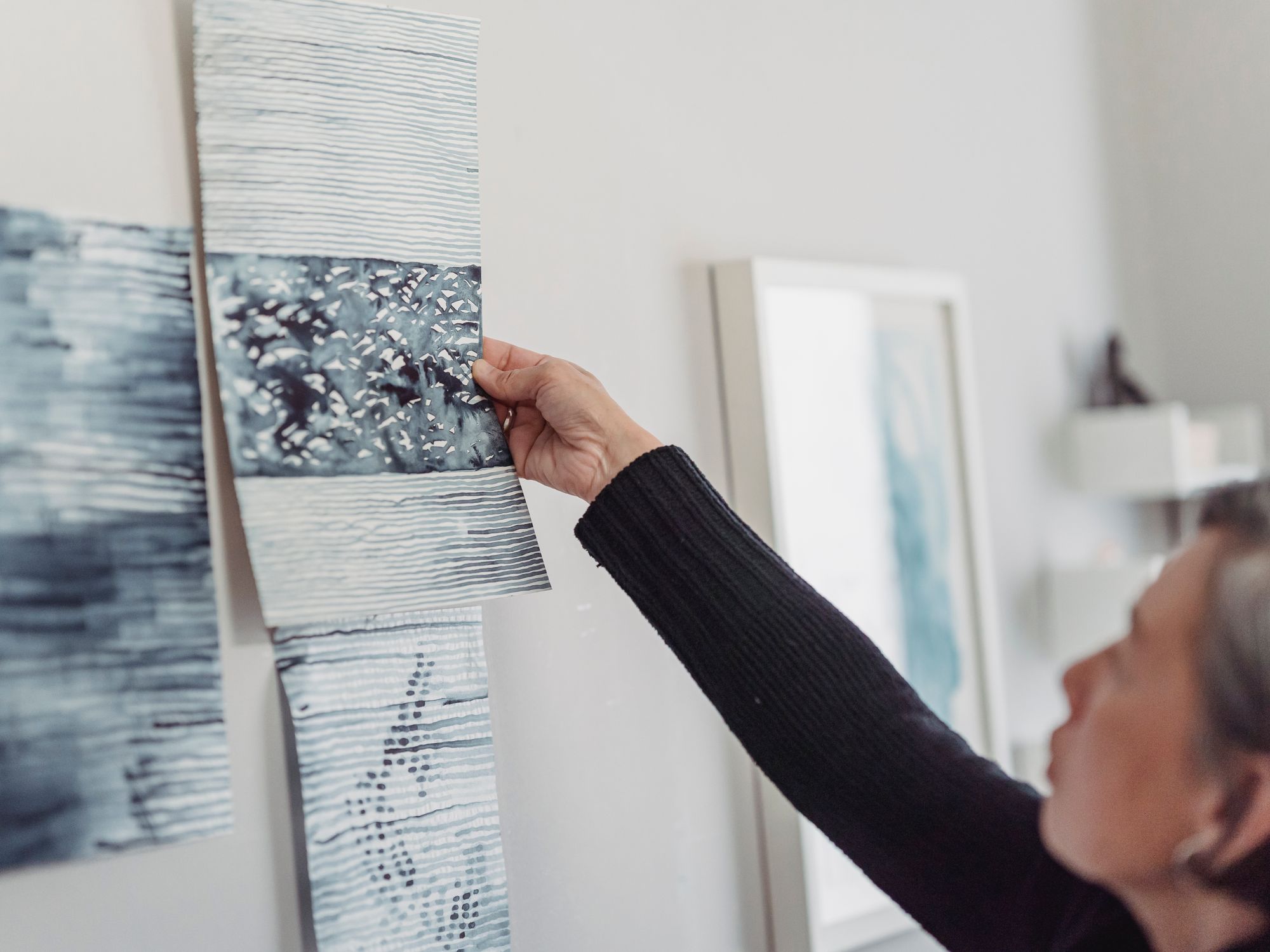 Wallpapering in Spitalfields, Tower Hamlets — decorator hanging pattern-matched wallpaper