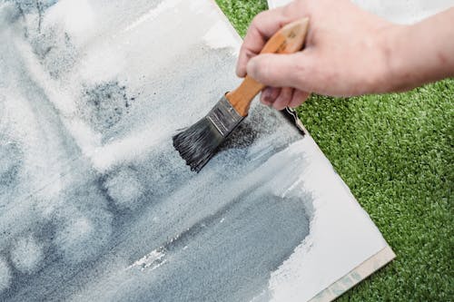 Close-Up Shot of a Painter Doing an Abstract Painting