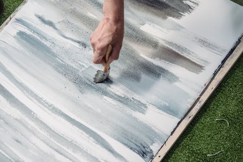 Close-Up Shot of a Painter Doing an Abstract Painting