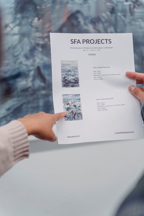 Free Close-Up Photo of a Person Pointing Her Finger at the Paper Stock Photo
