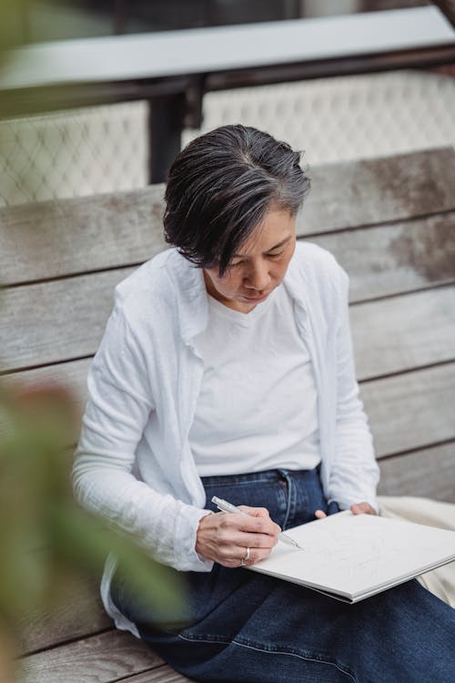 Woman Drawing an Artwork in a Sketchpad