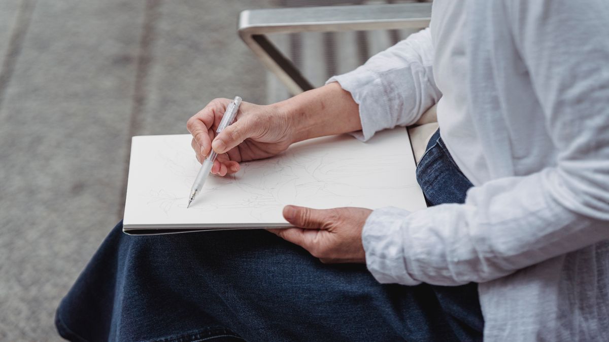 Person sketching a personal map in a notebook