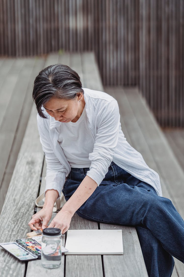 A Woman Painting An Artwork