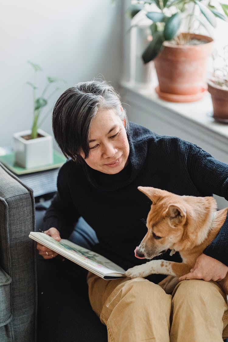 Woman Playing With Her Dog