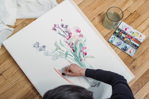 High-Angle Shot of a Person Painting an Artwork