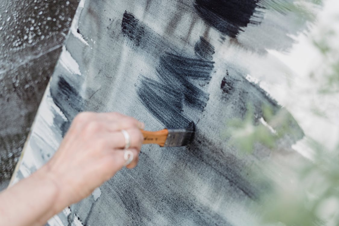 Close-Up Shot of a Painter Doing an Abstract Painting