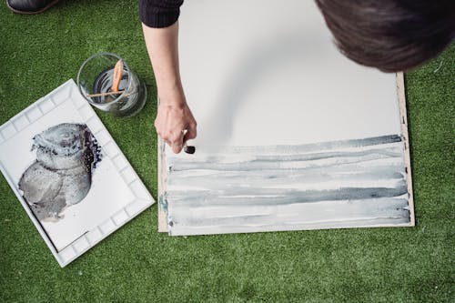 High-Angle Shot of a Person Painting an Artwork