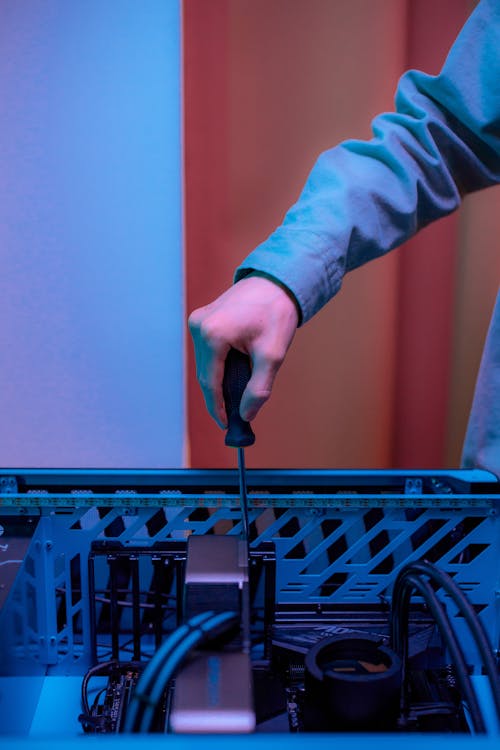 Man Screwing a Screw into a Computer