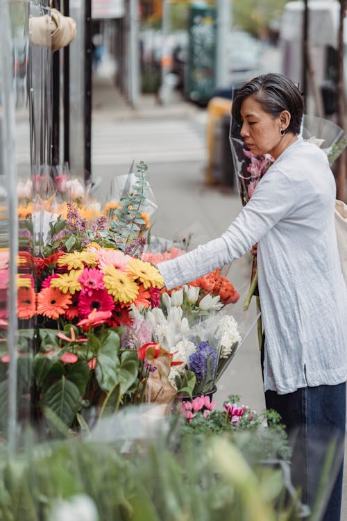 A Woman Looking at the Blooming Flowers