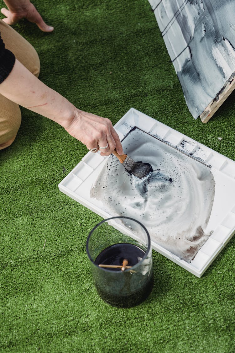 High-Angle Shot Of A Painter Mixing The Color In A Palette