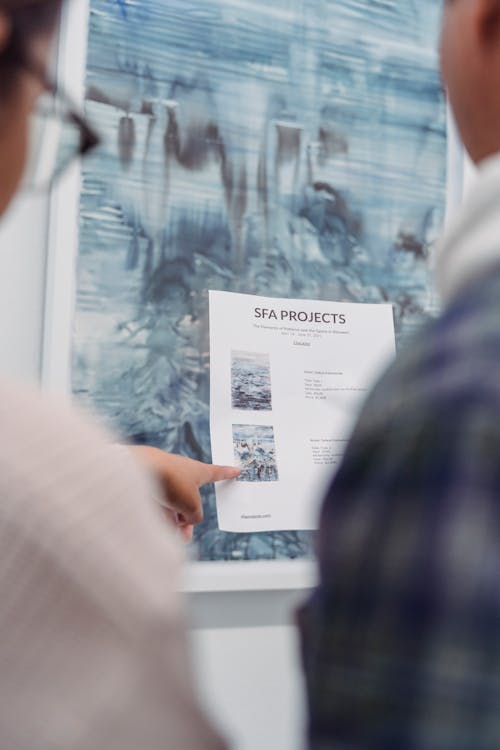 Close-Up Photo of a Person Pointing Her Finger at the Paper