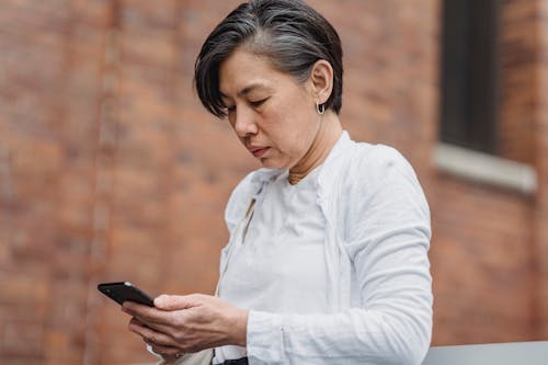 A Woman Busy Using Her Smartphone