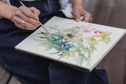 Close-Up Photo of a Person Painting an Artwork