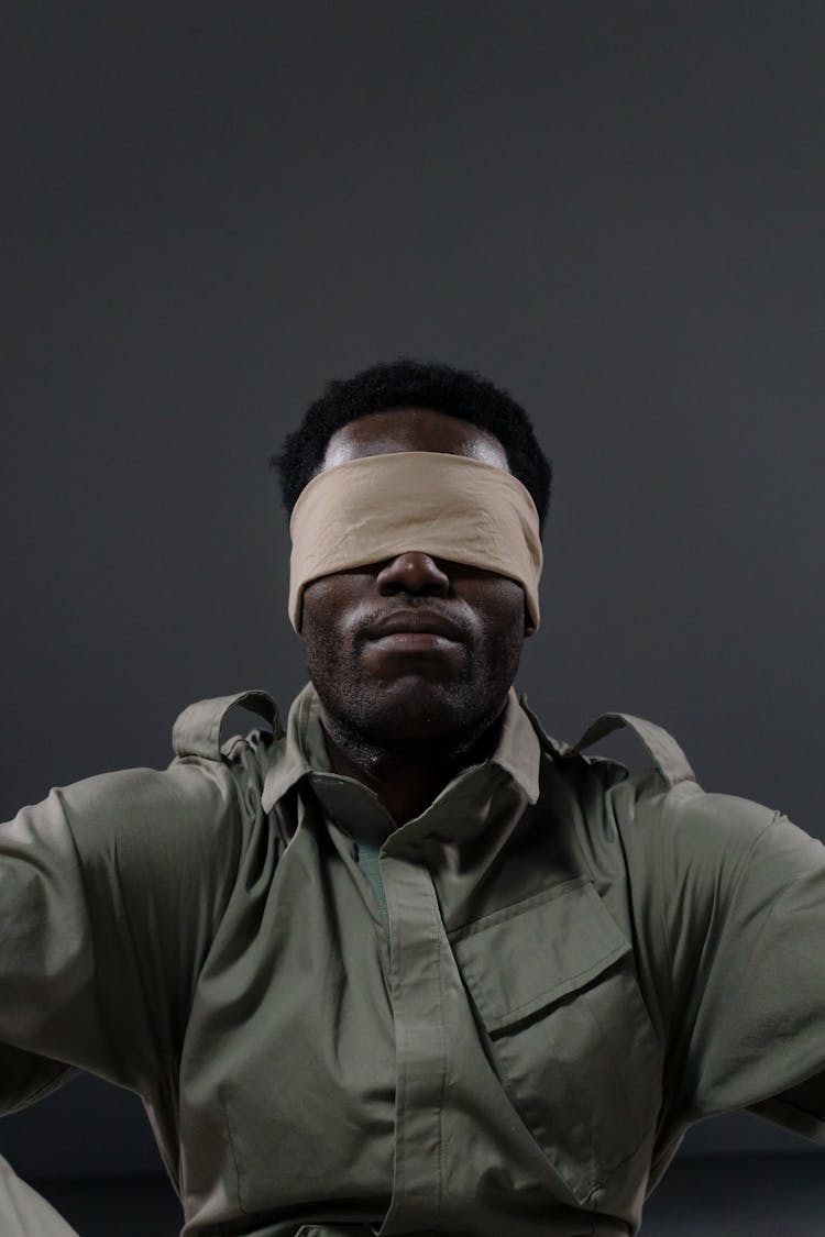 Man With Blindfold Sitting 