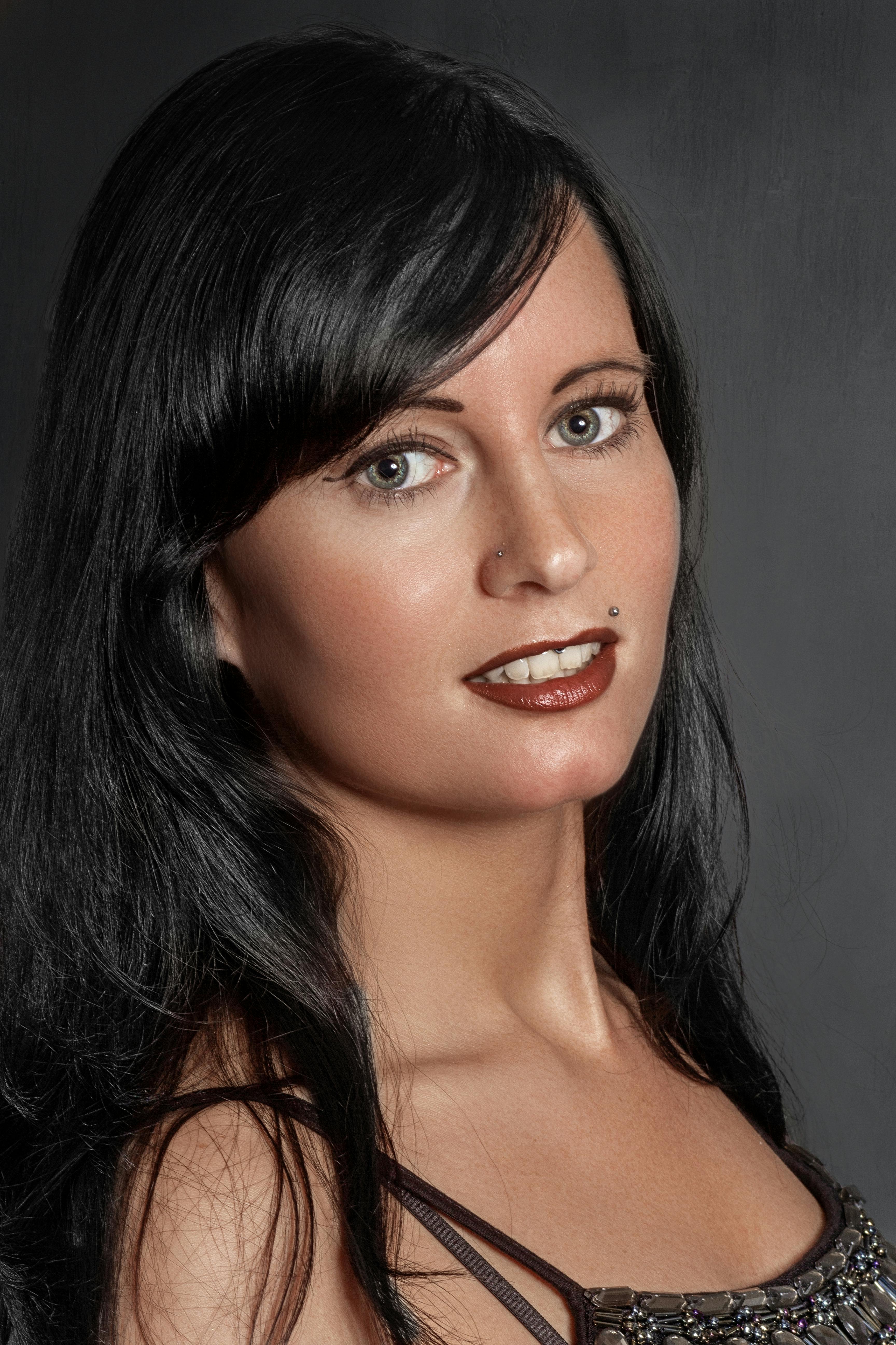 Elegant portrait of a woman wearing makeup with black hair, showcasing beauty and style.