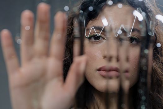 Pretty Woman Touching a Glass Panel