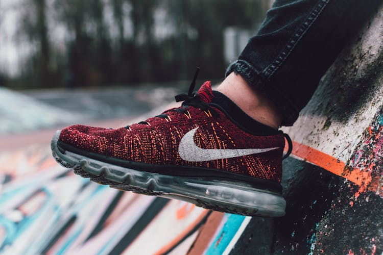 Close-Up Photography Of Red And Black Nike Running Shoe