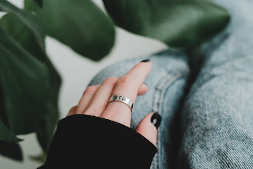 Close-Up Shot of Hand Wearing Silver Ring 