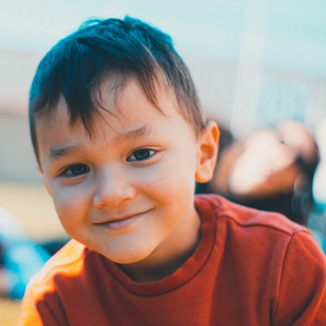 child smiling warmly in a dental chair