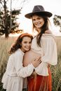 Pregnant woman with daughter in countryside