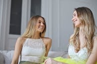 两个年轻女子在室内的沙发上一起大笑