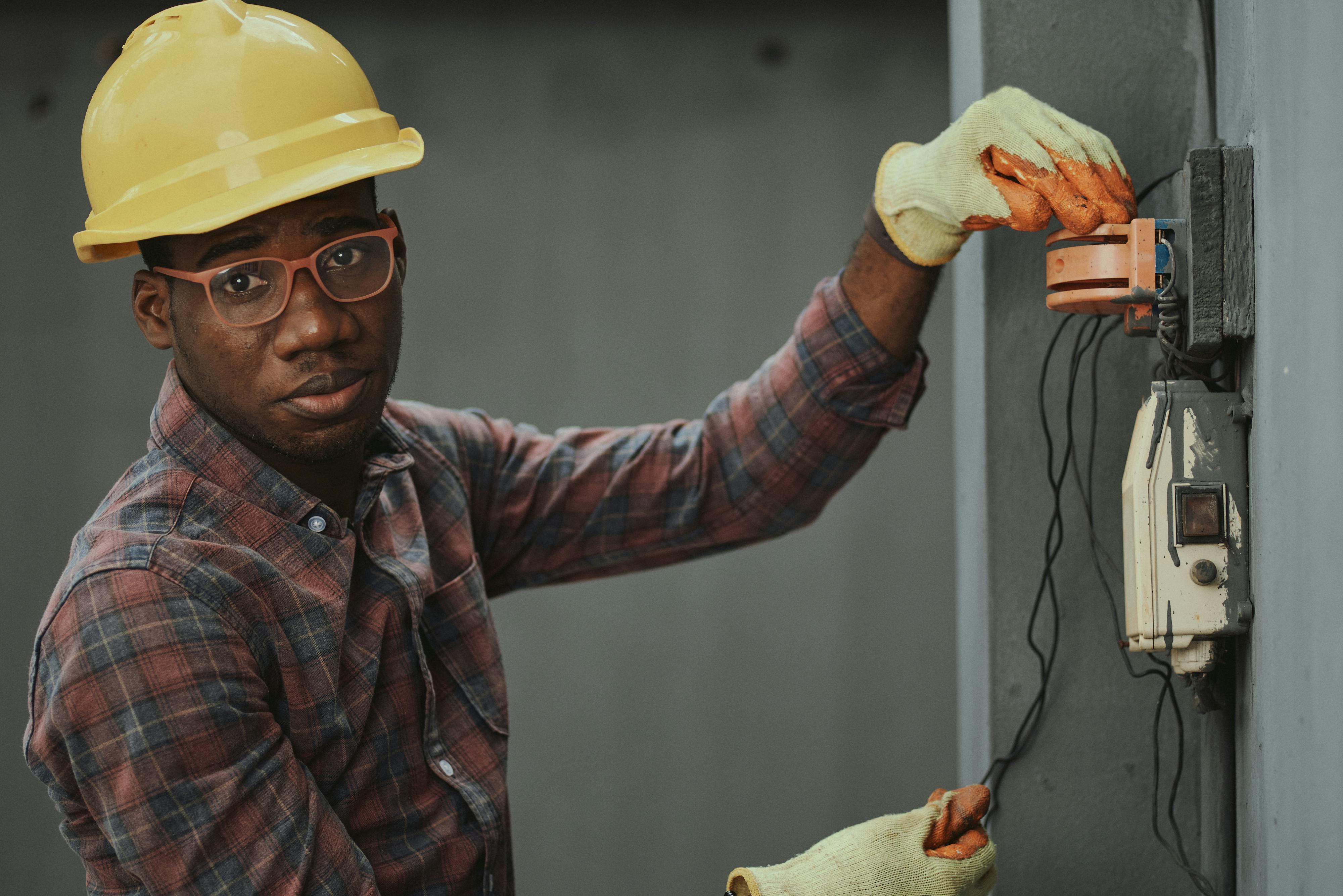 an electrician repairing a fuse box