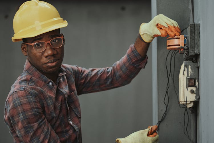 An Electrician Repairing A Fuse Box