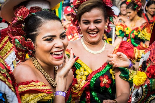 Women in colorful traditional costumes celebrating Barranquilla Carnival in Colombia.