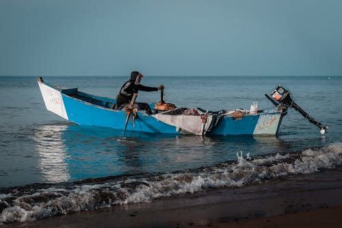 A Person Sitting on a Wooden Boat