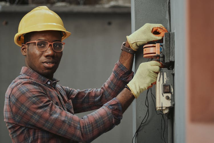 An Electrician Repairing A Fuse Box