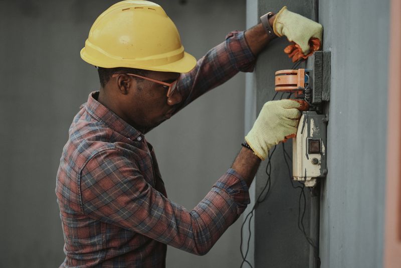 Electrician repairing a distribution board during fit-out