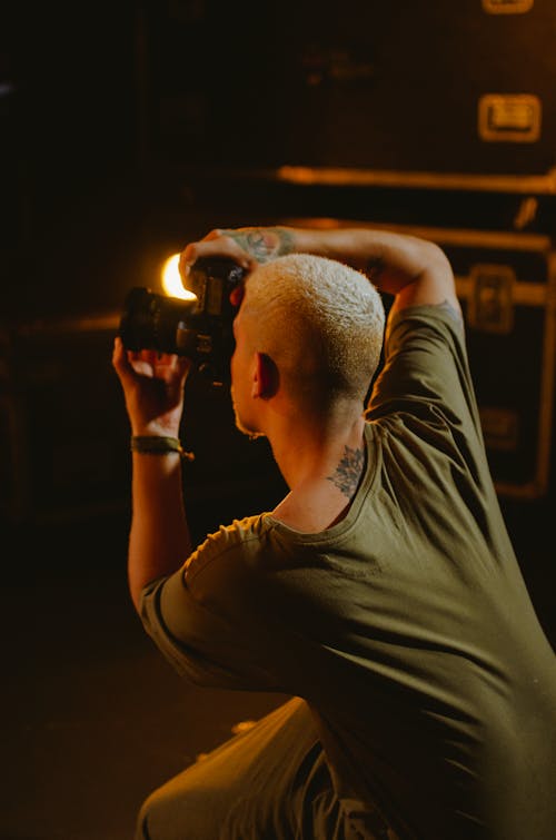 Free Man in Green Shirt Taking a Picture Stock Photo