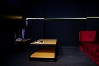 A sleek gaming room featuring controllers and vibrant furniture, ideal for entertainment enthusiasts.