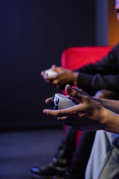 Hands holding game controllers in a vibrant gaming session indoors, focusing on the action.