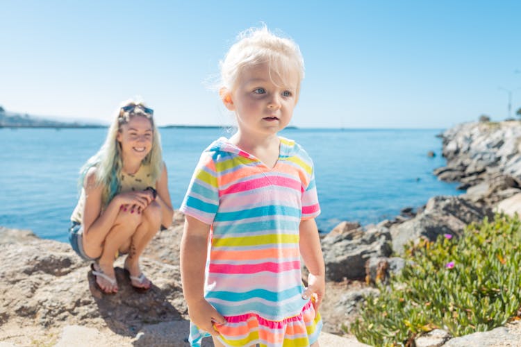 A Young Girl In Colorful Dress With Blonde Hair