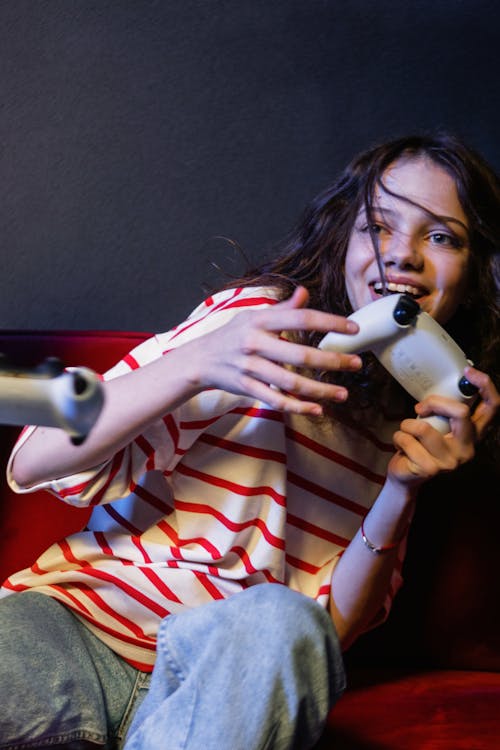 A Woman in Striped Shirt Holding a Game Controller