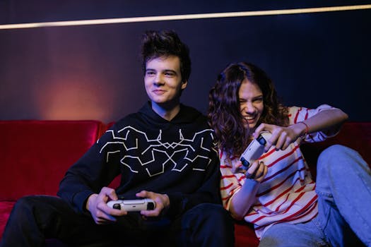 Two teenagers playing video games together, smiling and enjoying the moment indoors.