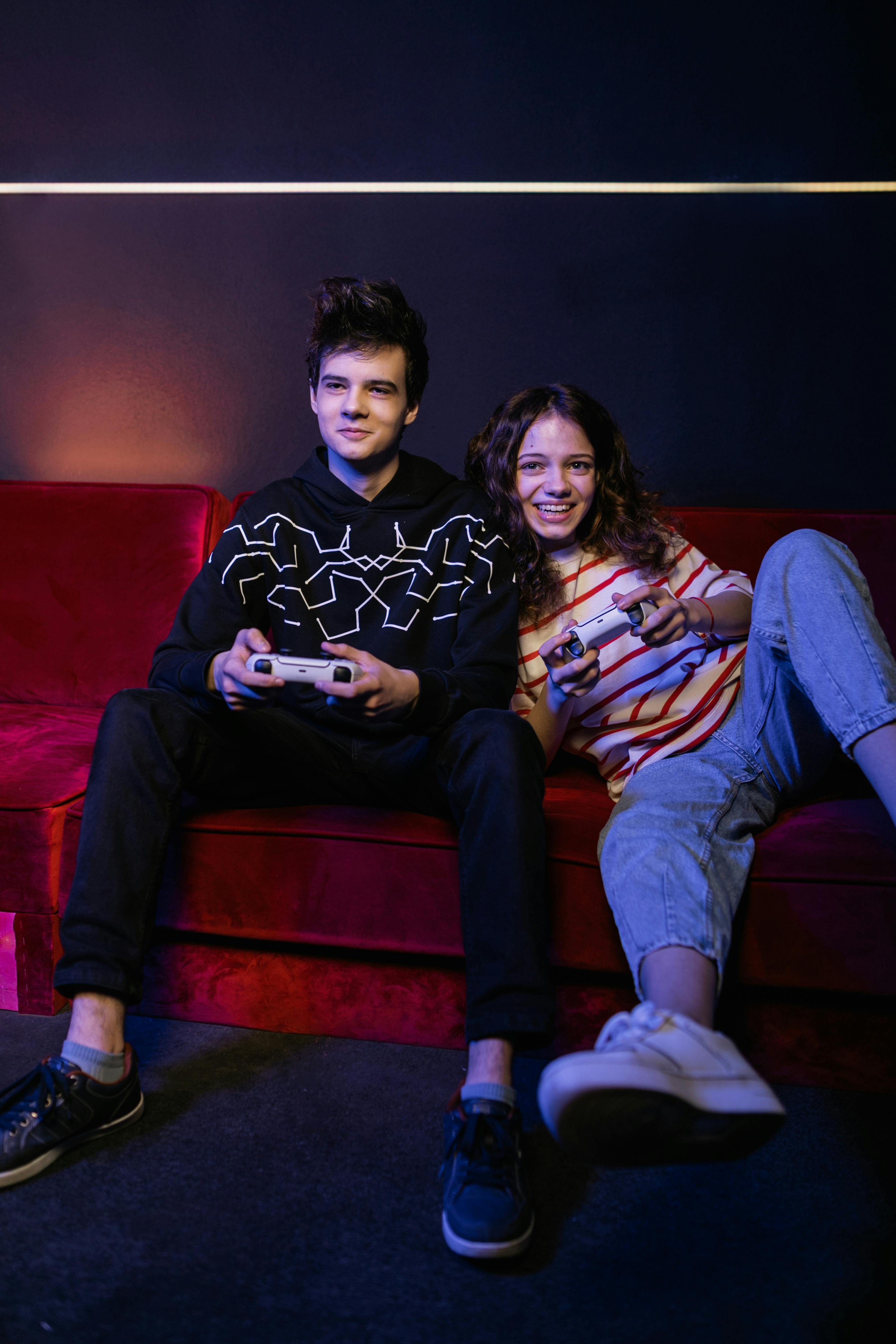 teens sitting on red couch