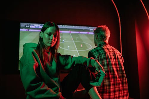 A Woman in a Hoodie Sweater Holding a Video Game Controller