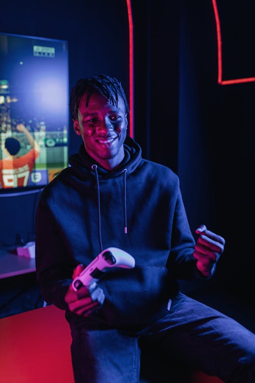 A Man in Black Hoodie Sweater Holding a Game Controller