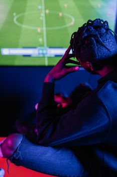 A young adult intensely focused on a video game screen, capturing the essence of modern gaming culture.