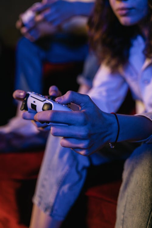 Free A Person Holding a Wireless Game Controller Stock Photo