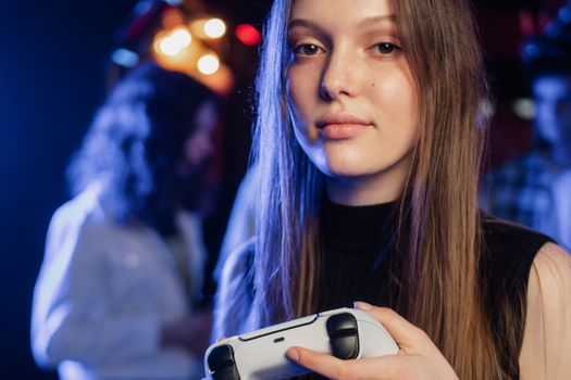 Close-up of a woman holding a video game controller with blurred background. Ideal for gaming and lifestyle themes.