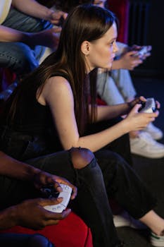 Friends enjoying an intense gaming session indoors with wireless controllers.