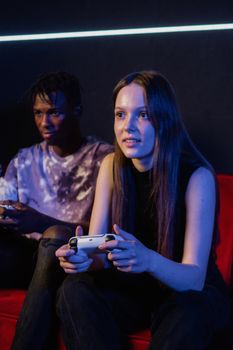 Two friends enjoying a fun gaming session indoors. Vibrant atmosphere and engaging expression.
