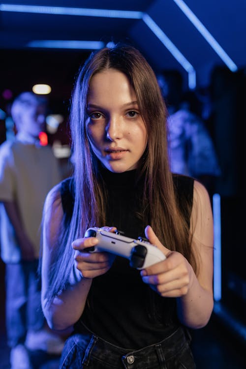 Free Shallow Focus of a Girl Holding a Game Controller Stock Photo