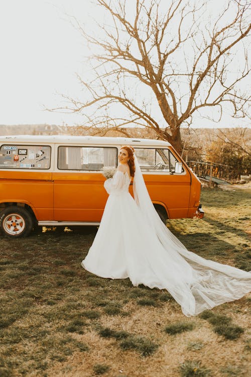 Free A Beautiful Bride and an Orange Microbus Stock Photo