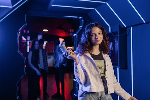 Young girl immersed in a gaming environment, holding a game controller in a neon-lit arcade.